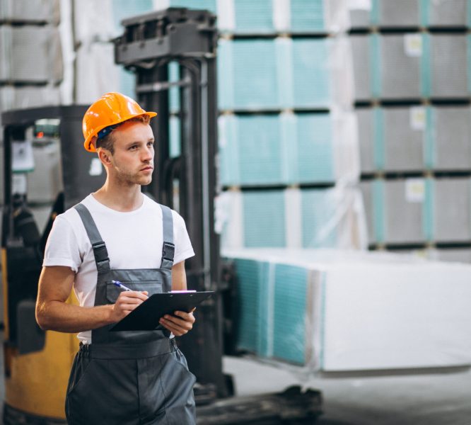 Young man working at a warehouse with boxes