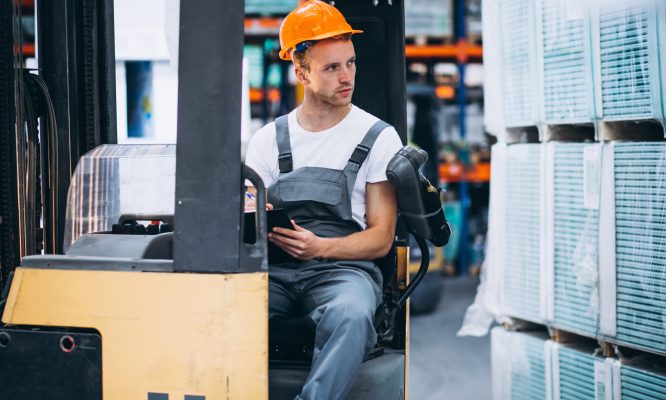 Young man working at a warehouse with boxes